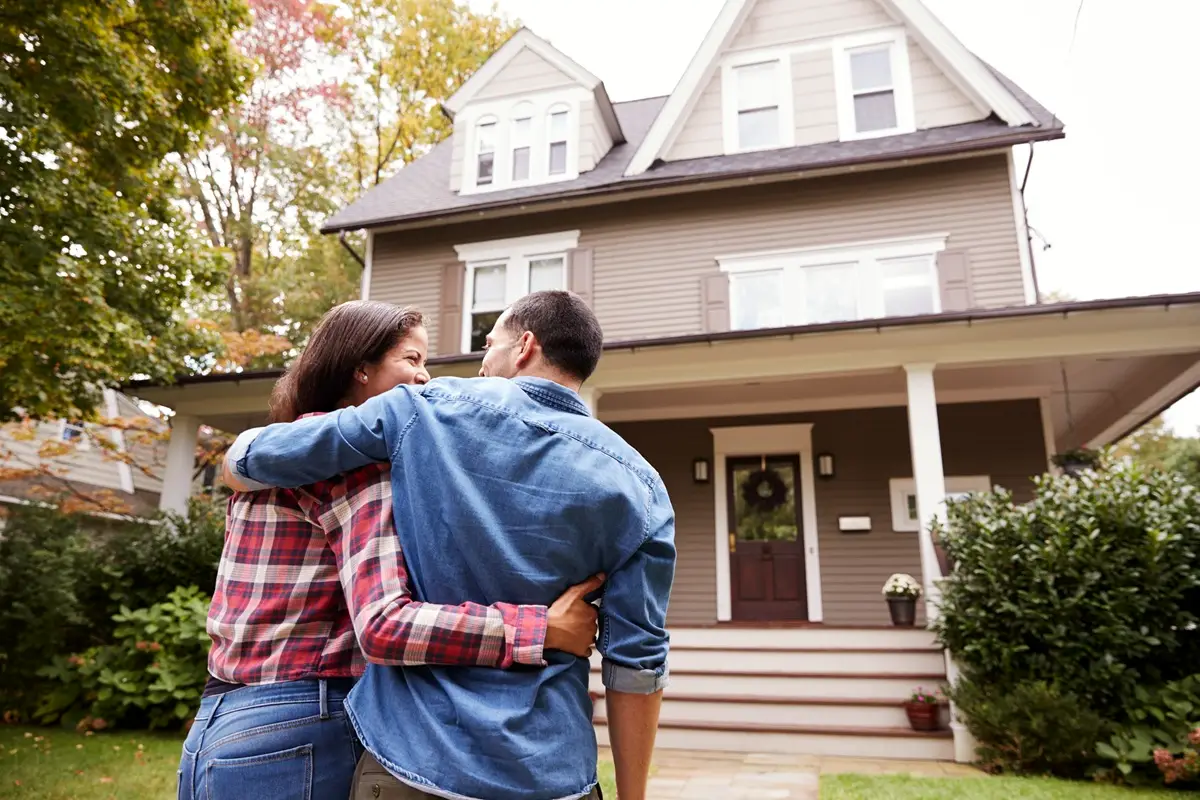 ensure buyers agency rear view loving couple walking towards house